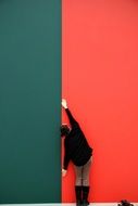 woman posing on the colored wall background