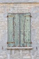 old green wooden shutters on the window
