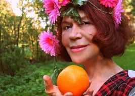 Portrait of smiling woman with flowers on her head