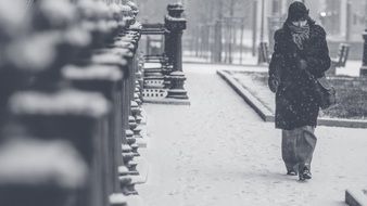 woman among city street in a blizzard