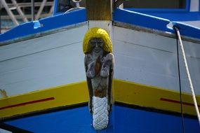 decorative sculpture of a woman on the bow of a boat