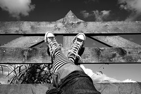 legs in jeans and sneakers in black and white image