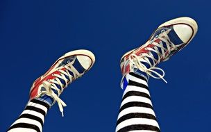 legs in striped tights and sneakers