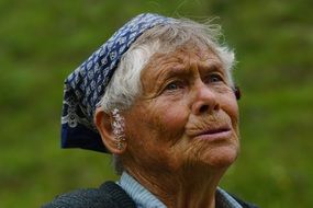 Elderly Woman with flowers on ears, Portrait