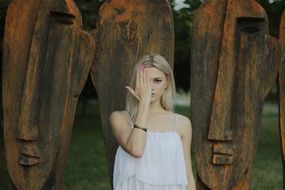 blonde girl covers her face