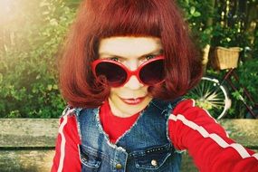 portrait of a funny red hair woman in sunglasses