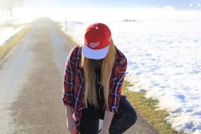 girl in a red baseball cap on the beach