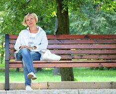 blonde woman sitting on a bench