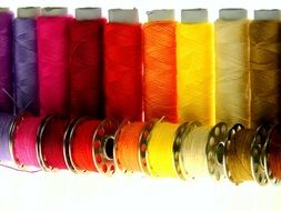 colorful sewing threads on a white background