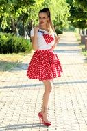 Girl in Fashion Dress on the alley in the park