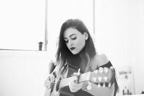 Musician, young girl plays guitar, Black and White