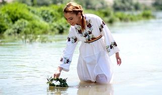 girl in an embroidered dress on the water