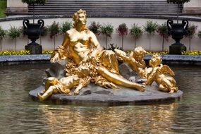 gilded fountain statues in linderhof palace