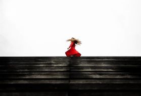 girl in a red dress on the horizon