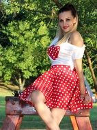 blonde with heart on her chest in the park
