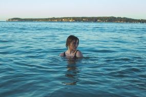 woman swims in the lake