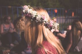 side view of long haired girl in wreath on head