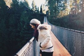 girl looking down the suspension bridge