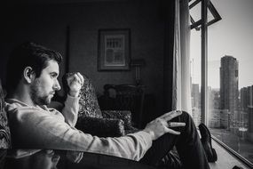 young man see in window black and white photo