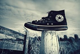 sports shoes on a stump in black and white background