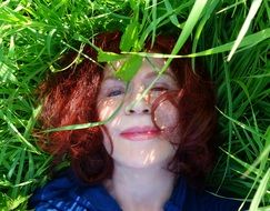 happy girl lying on green grass