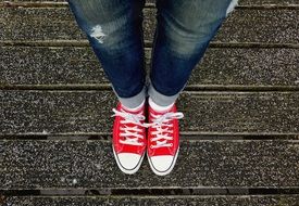 girl in jeans and red sneakers