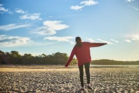 girl in a red jacket on the beach