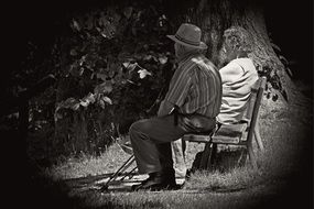 black and white photo of an elderly couple on a bench