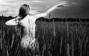 naked model on the field in black and white