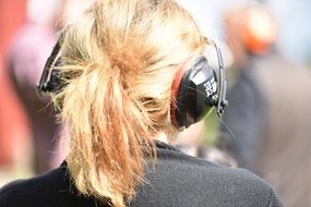 rear view of blonde in headphones