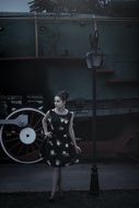 pin up model posing on a locomotive background