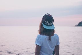 woman looks into the distance to the ocean