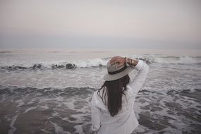 woman in hat on the sea beach