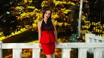 photo of posing young woman in red skirt