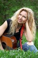 Musician sitting on a grass