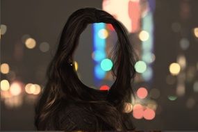 female hairstyle against the background of night neon lights