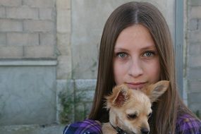 Young long haired Girl with small dog, head portrait