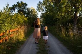 woman with a child on a dirt road