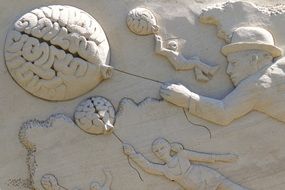 creative sculpture of a child with a balloon-brain