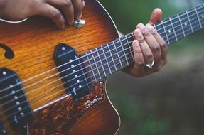 Musician playing with the beautiful wooden guitar