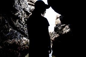 silhouette of human in a cave