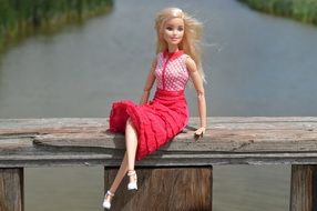 nice Barbie Doll sits outdoor