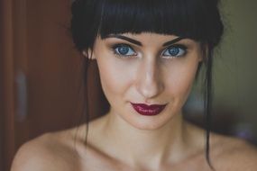 Portrait of a girl with dark lipstick on her lips