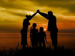 family near the lake at sunset