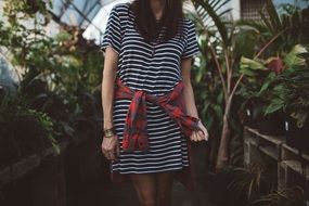 Woman in Stripped Dress among potted plants