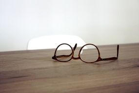 glasses lie on a table in the sunlight