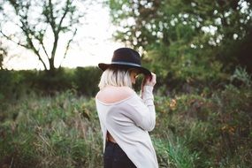 woman in white sweater and hat