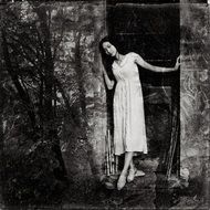 Black and white photo of the woman in the dark forest