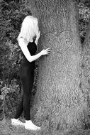 young woman shooting in the forest