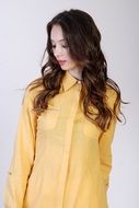 long haired brunette in a yellow shirt